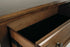 Flynnter Medium Brown Five Drawer Chest