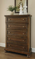 Flynnter Medium Brown Five Drawer Chest
